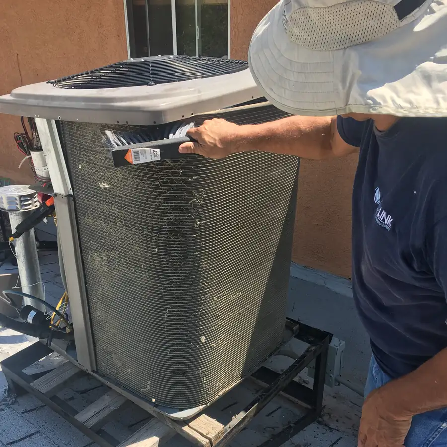 AirLink technician performing AC maintenance